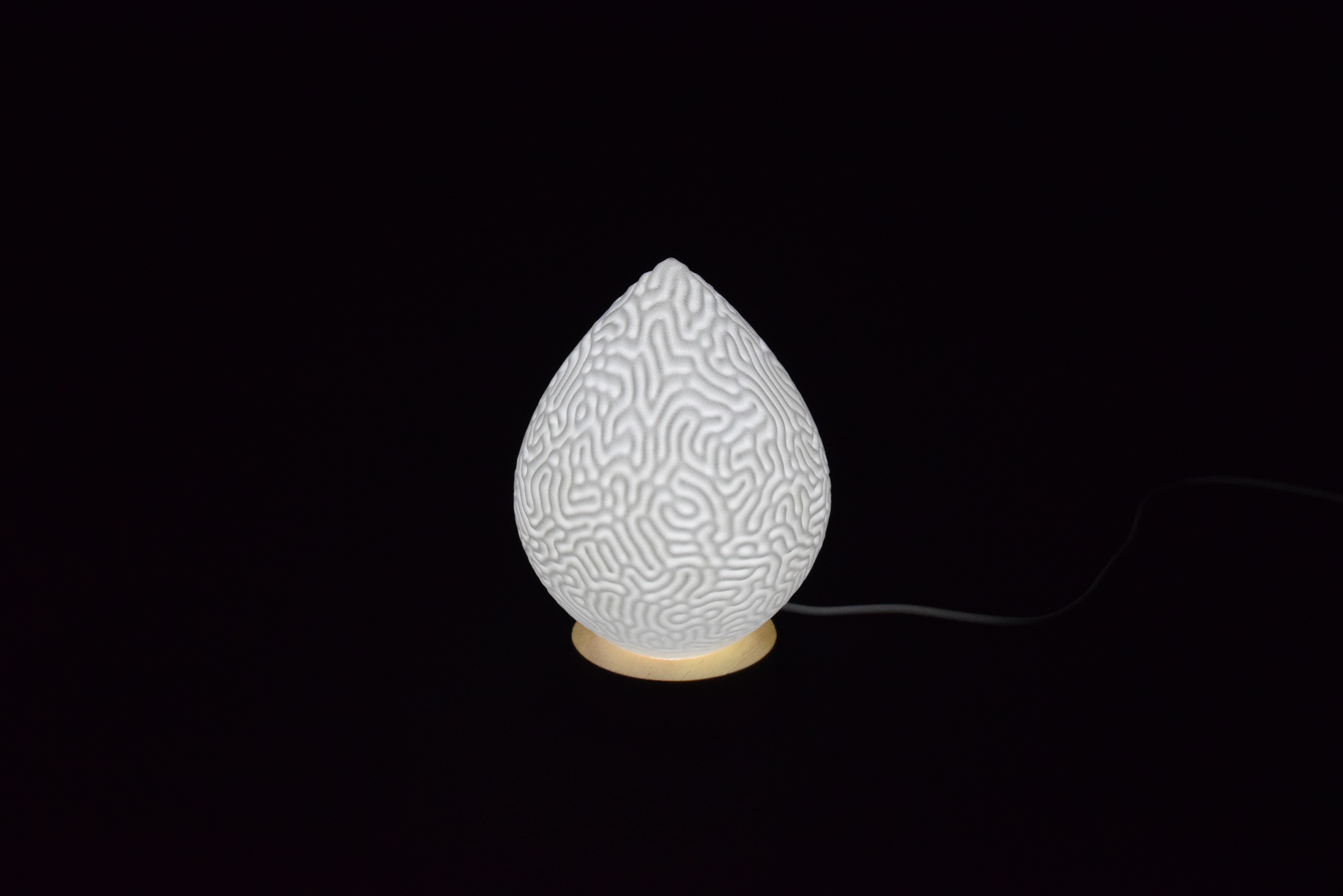 Decorative suggestion for Cosmic Drop: Desktop light with cosmic design. Encapsulates the beauty of the cosmos - variant Aeolian Plains (Elegant white), an original product by Cosmic Jubilee (1 of 5) - presented as desktop, table, or freestanding light, switched on.