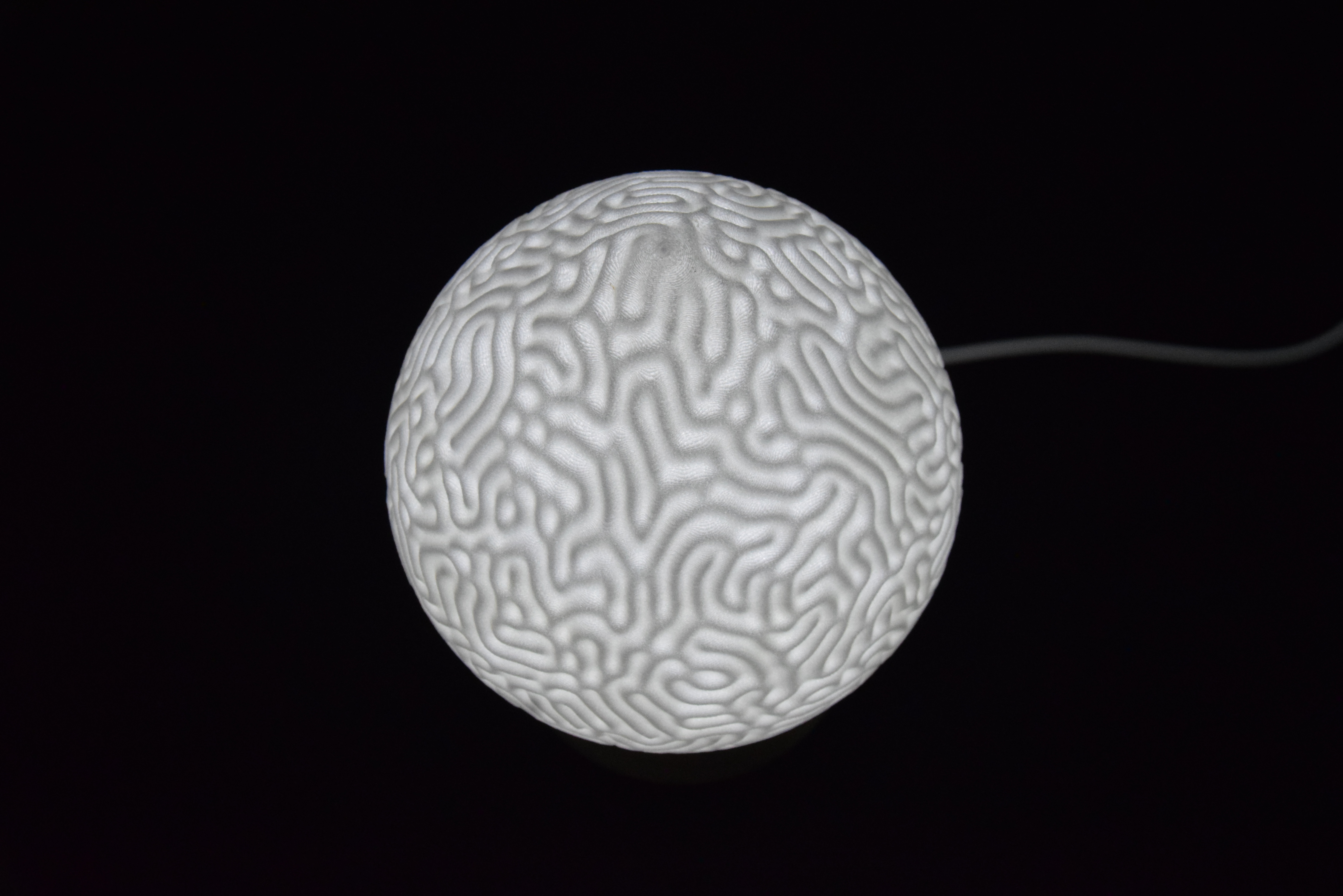Decorative suggestion for Cosmic Drop: Desktop light with cosmic design. Encapsulates the beauty of the cosmos - variant Aeolian Plains (Elegant white), an original product by Cosmic Jubilee (3 of 5) - presented as desktop, table, or freestanding light, switched on.