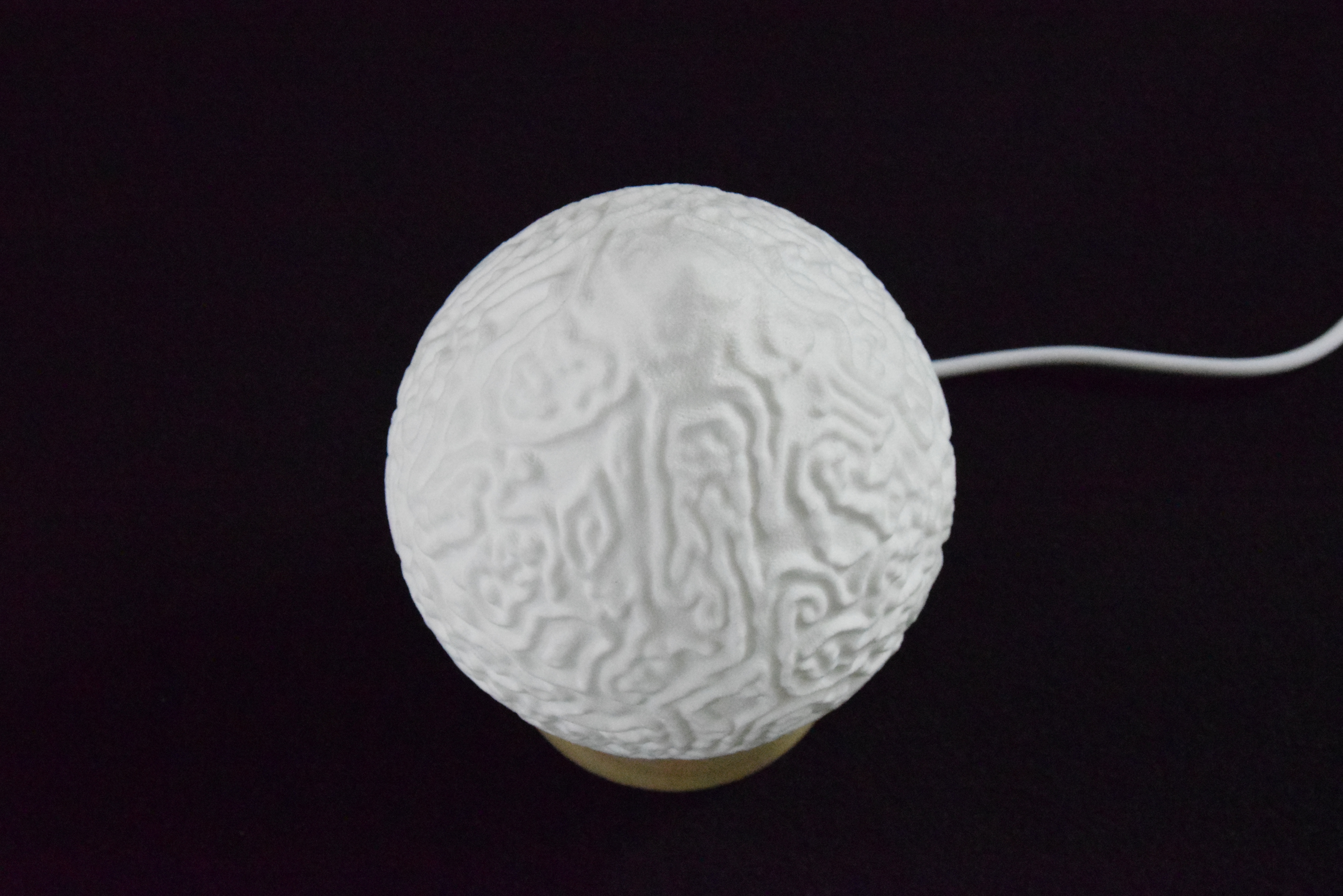 Decorative suggestion for Cosmic Drop: Desktop light with cosmic design. Encapsulates the beauty of the cosmos - variant Alluvial Crush (Elegant white), an original product by Cosmic Jubilee (4 of 5) - presented as desktop, table, or freestanding light, switched off.