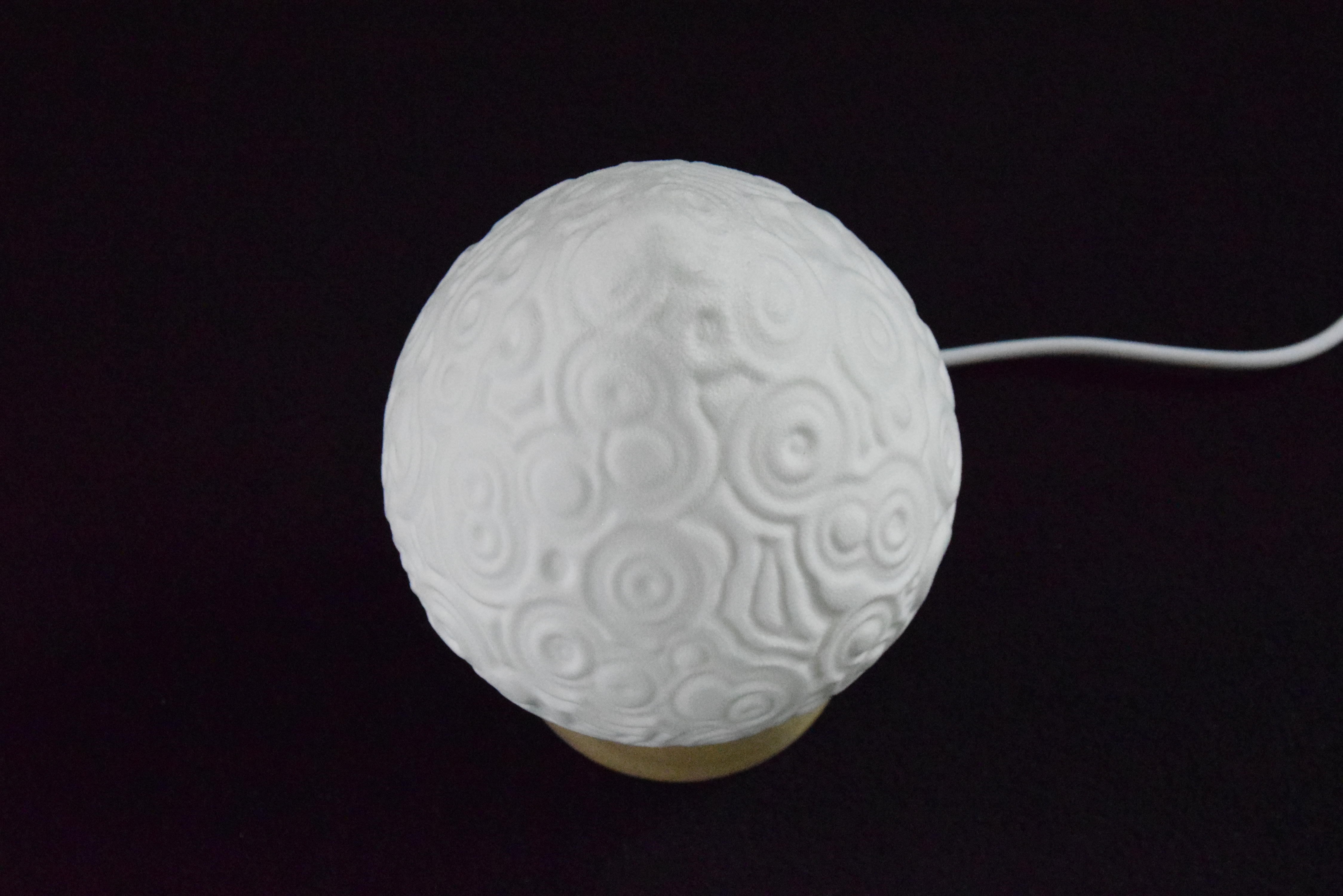 Decorative suggestion for Cosmic Drop: Desktop light with cosmic design. Encapsulates the beauty of the cosmos - variant Celestial Odyssey (Elegant white), an original product by Cosmic Jubilee (4 of 5) - presented as desktop, table, or freestanding light, switched off.