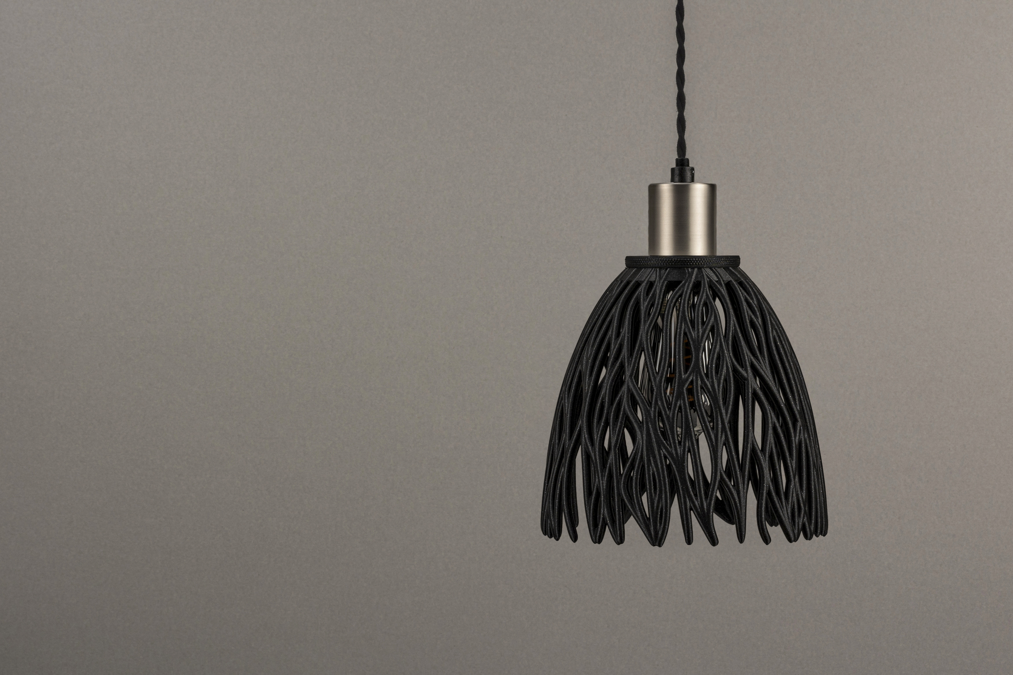 Decorative suggestion for Empyreal Bloom: Pendant lampshade with organic growth design. Mesmerizing shadow play for subtle elegance and ambiance - variant Original (Black with a hint of sparkle), an original product by Cosmic Jubilee (3 of 8) - presented as pendant light, hanging from ceiling, switched off.