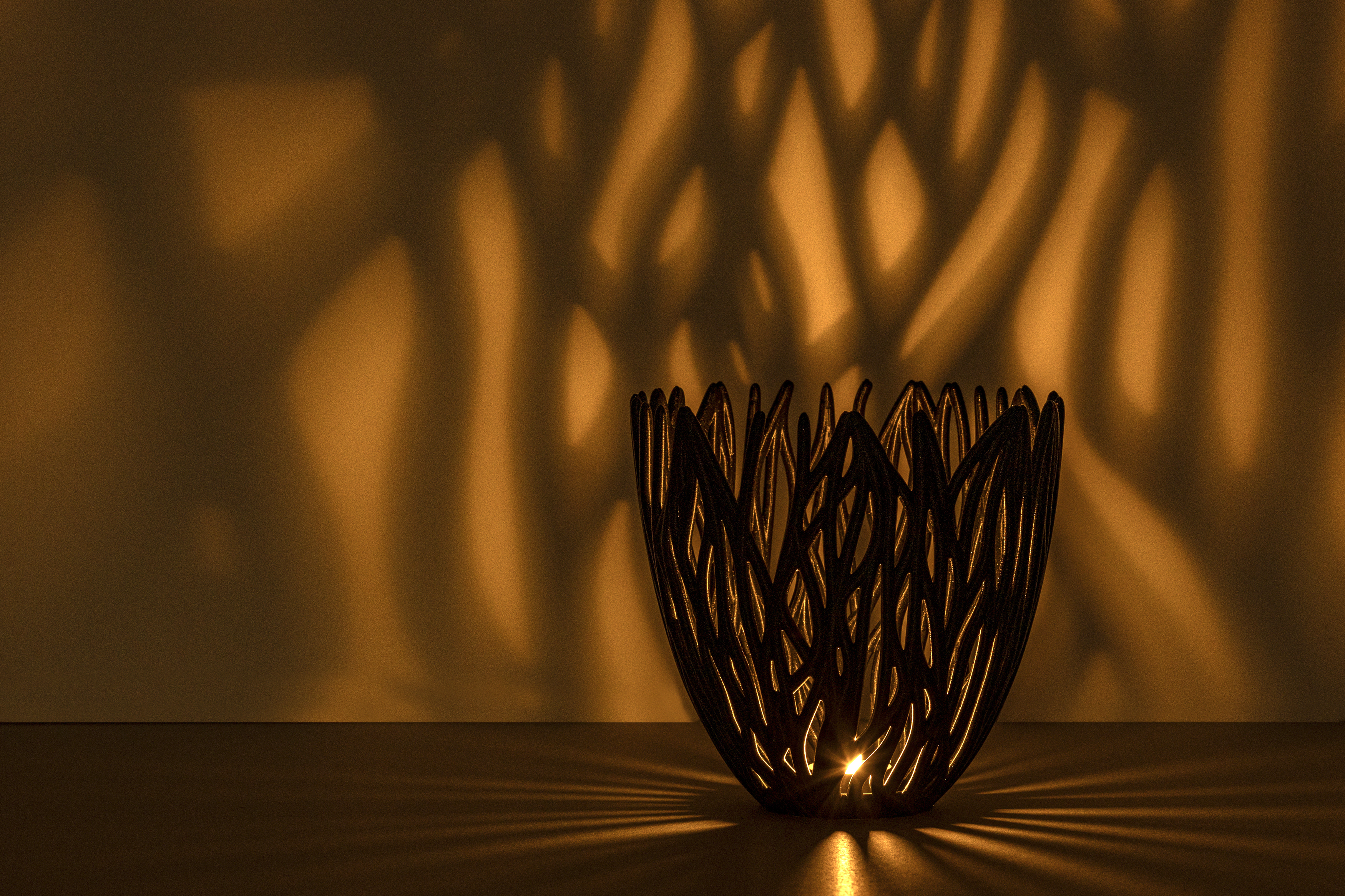Decorative suggestion for Empyreal Bloom: Pendant lampshade with organic growth design. Mesmerizing shadow play for subtle elegance and ambiance - variant Original (Black with a hint of sparkle), an original product by Cosmic Jubilee (6 of 8) - presented as tealight.