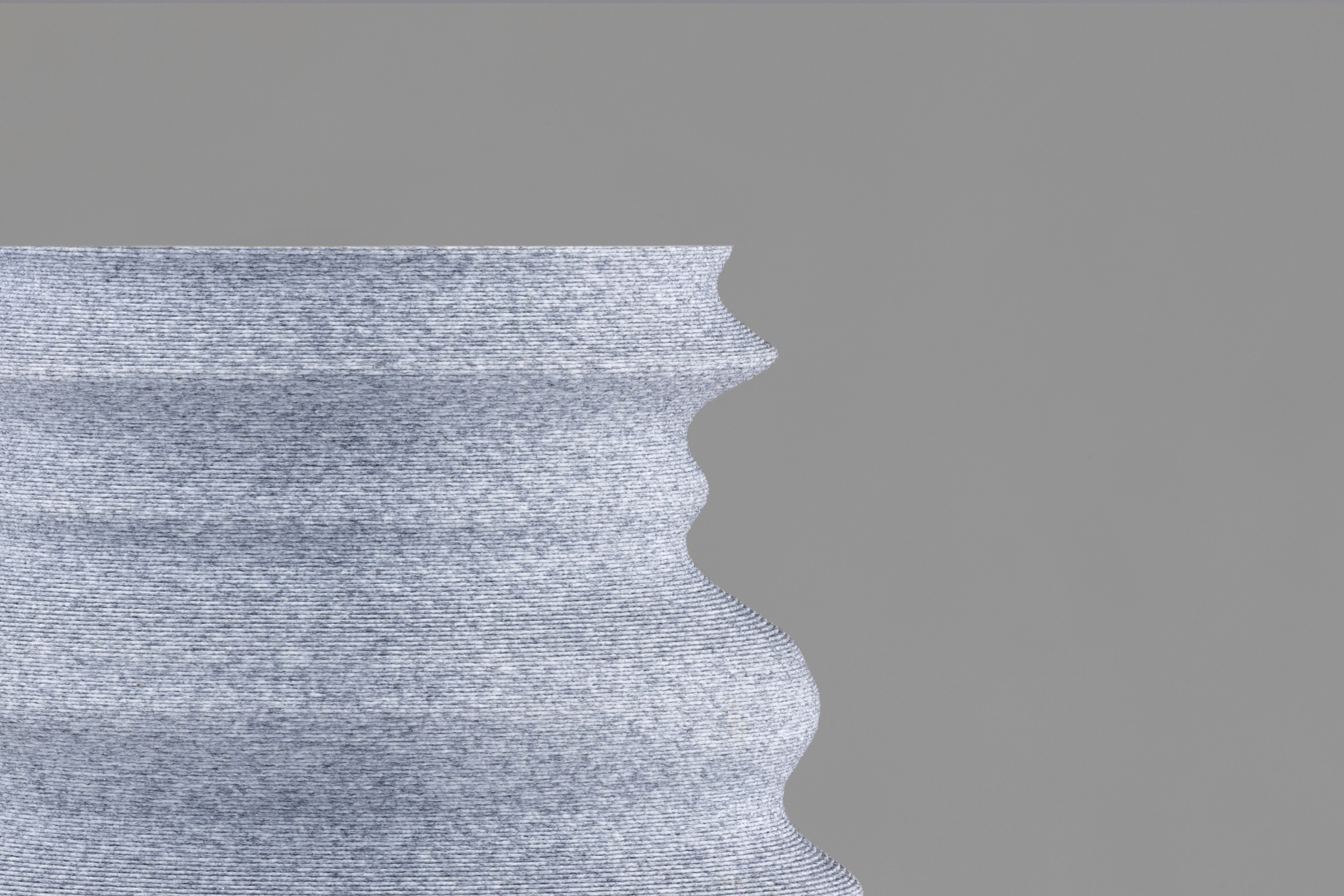 Decorative suggestion for Igneous Brim: Decorative (non-water) vase inspired by geological wonders. Textured design cradling dry flowers or standing alone as a decorative element - variant Granite Gray (Stony gray color and rough texture), an original product by Cosmic Jubilee (2 of 2) - presented as close-up details of fine textures.