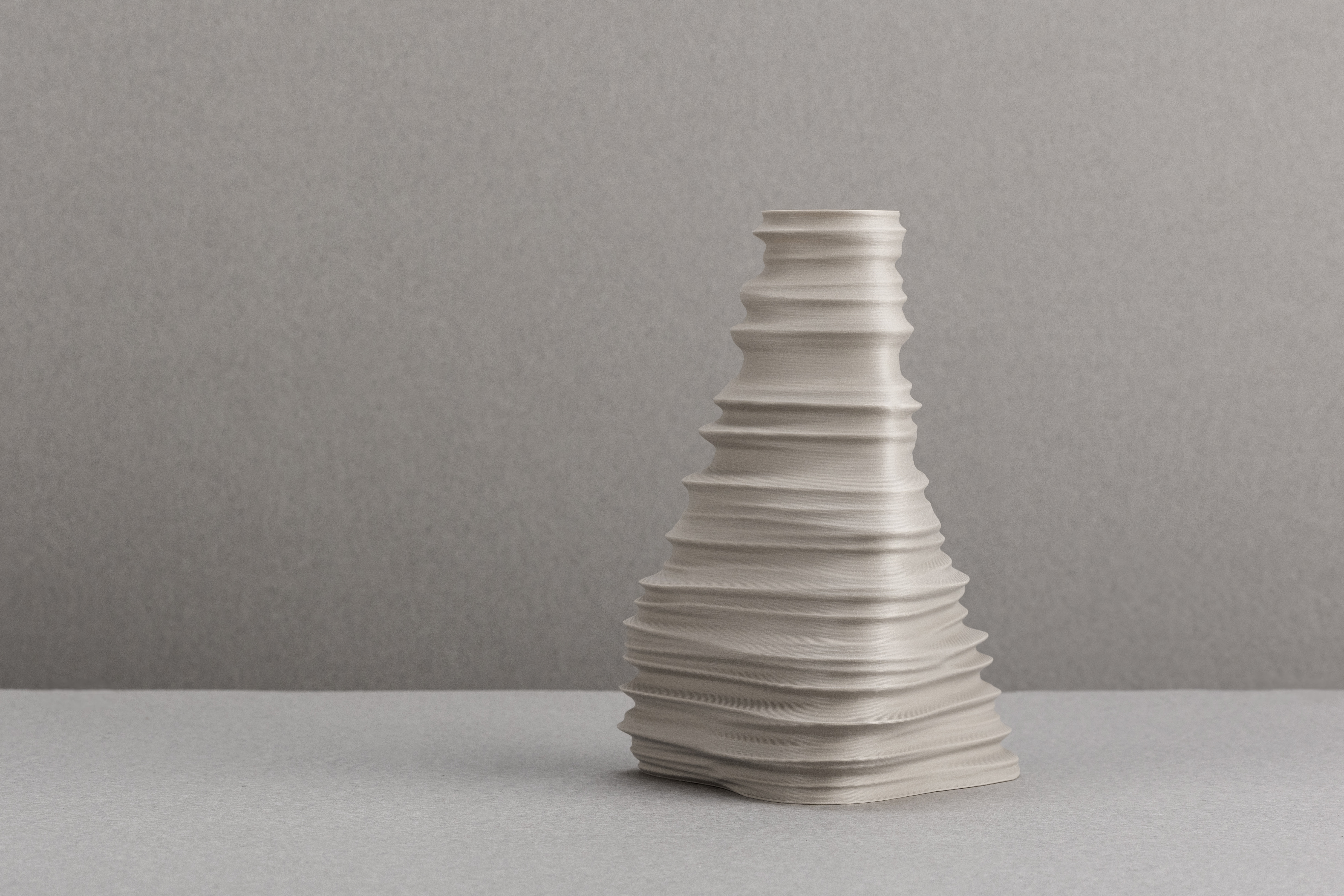 Decorative suggestion for Igneous Brim: Decorative (non-water) vase inspired by geological wonders. Textured design cradling dry flowers or standing alone as a decorative element - variant Original (Elegant stone color), an original product by Cosmic Jubilee (1 of 2) - presented as a decorative (non-water) vase or standalone showpiece.
