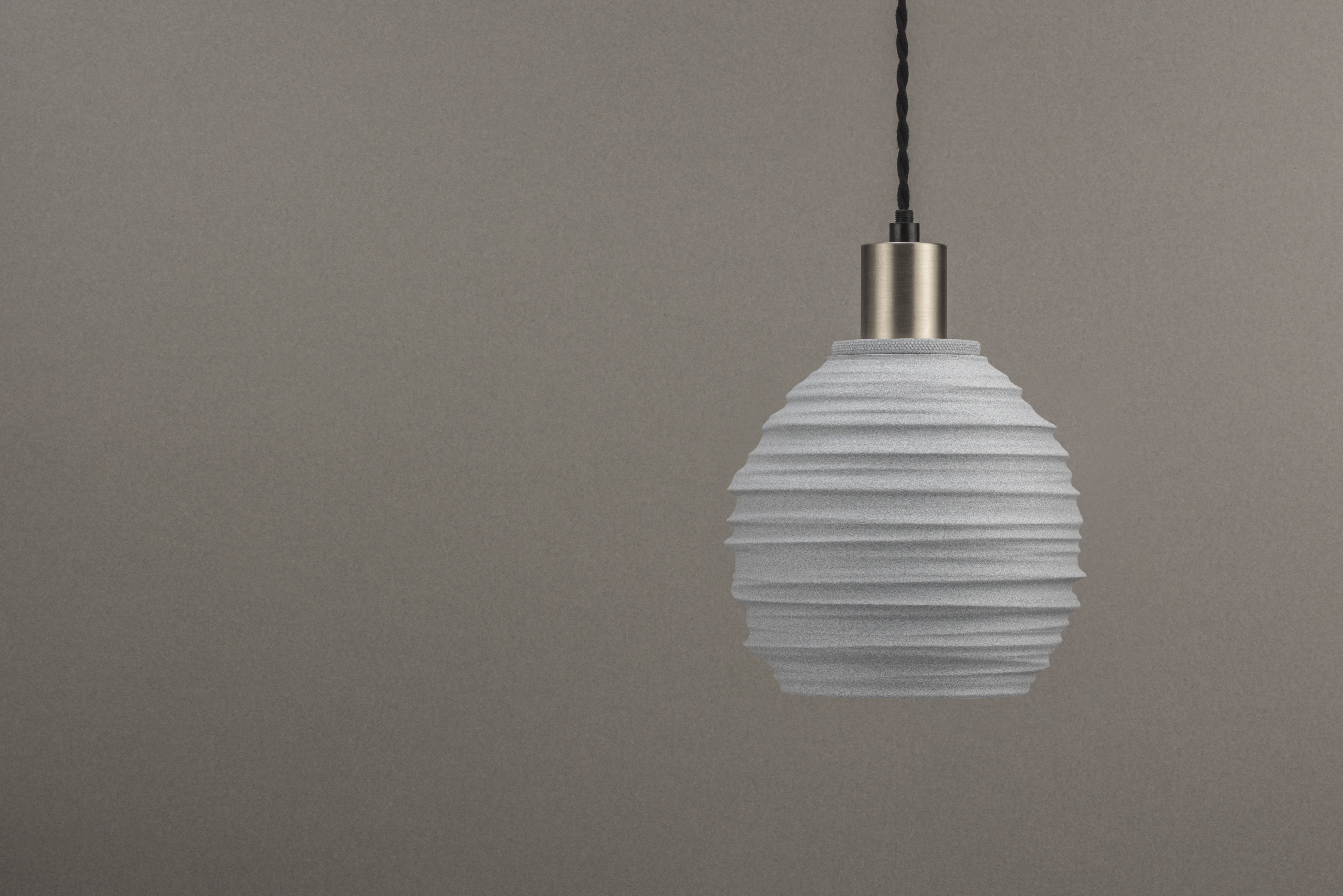 Decorative suggestion for Magma Shroud: Pendant lampshade mirroring tumultuous magma flow. Adds an elemental touch to modern decor - variant Granite Gray (Grainy textured stone gray spotlight), an original product by Cosmic Jubilee (2 of 6) - presented as pendant light, hanging from ceiling, switched off.