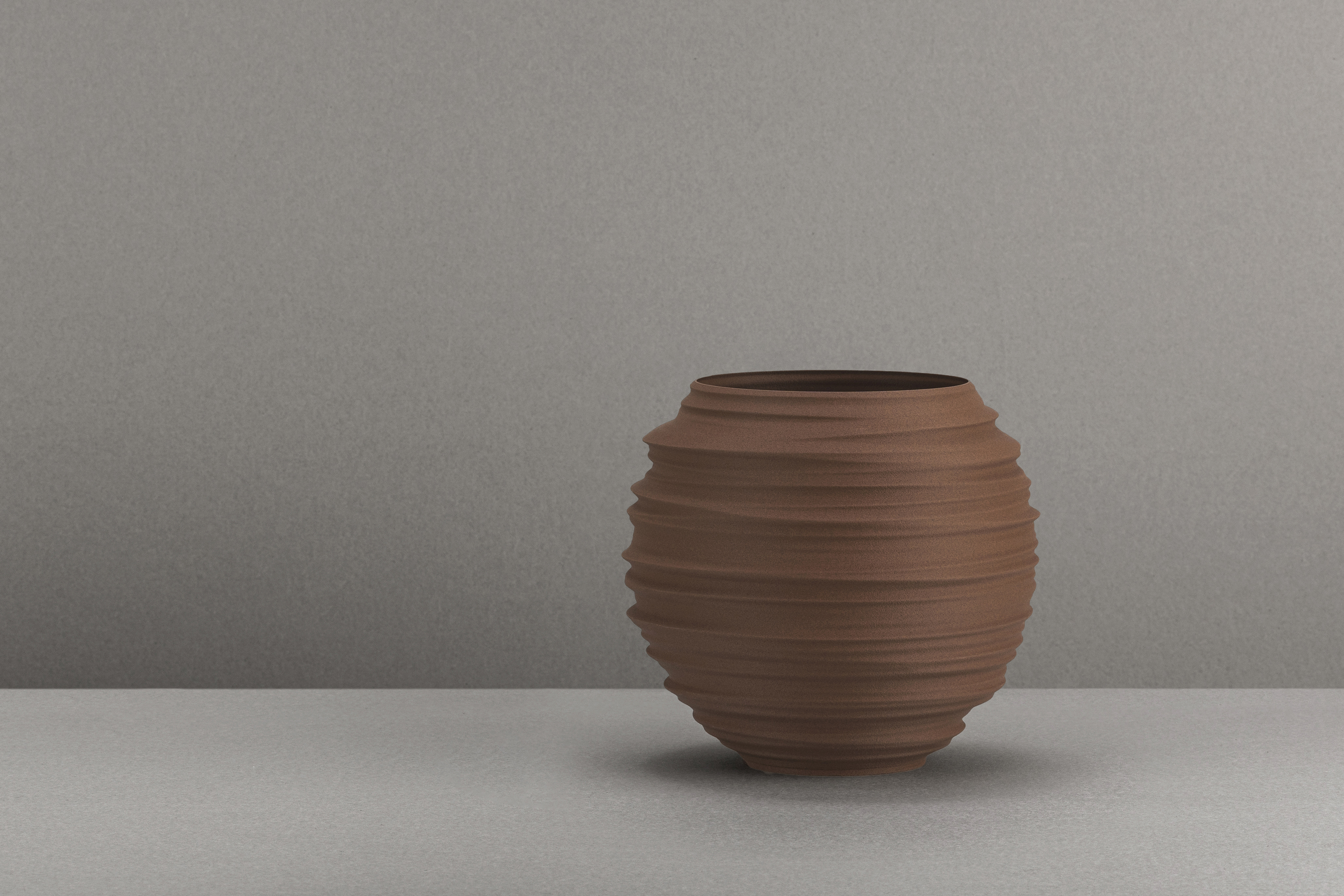Decorative suggestion for Magma Shroud: Pendant lampshade mirroring tumultuous magma flow. Adds an elemental touch to modern decor - variant Stone Red (Grainy textured stone red spotlight), an original product by Cosmic Jubilee (5 of 6) - presented as a decorative (non-water) vase or standalone showpiece.