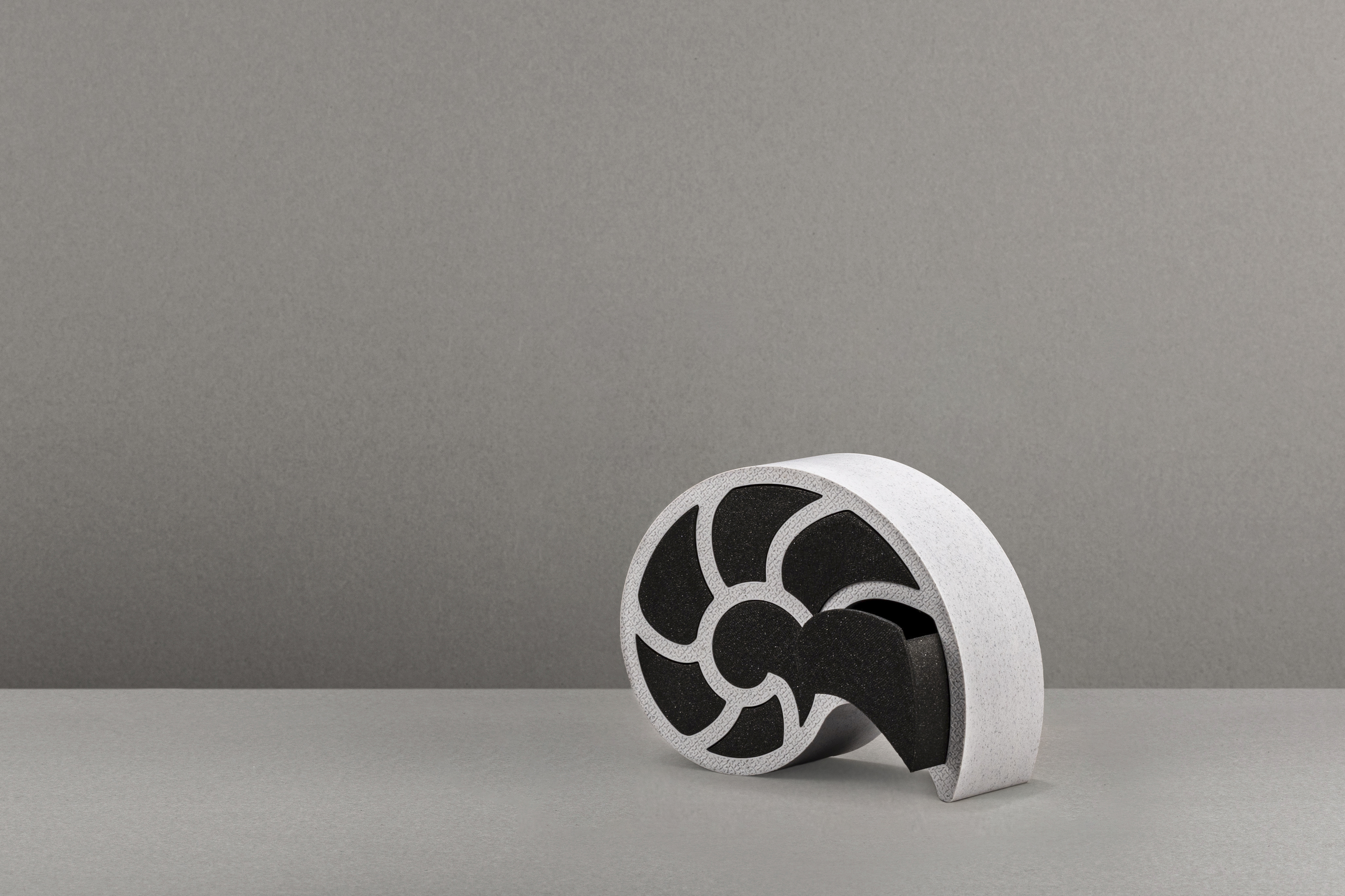 Decorative suggestion for Nausicaa's Treasure: Jewelry or trinket box modeled after the chambered nautilus shell. Ancient memories and echoes of the deep sea coalesce into a vessel for your valuables - variant Original (Stony gray), an original product by Cosmic Jubilee (2 of 5) - presented as single drawer open.