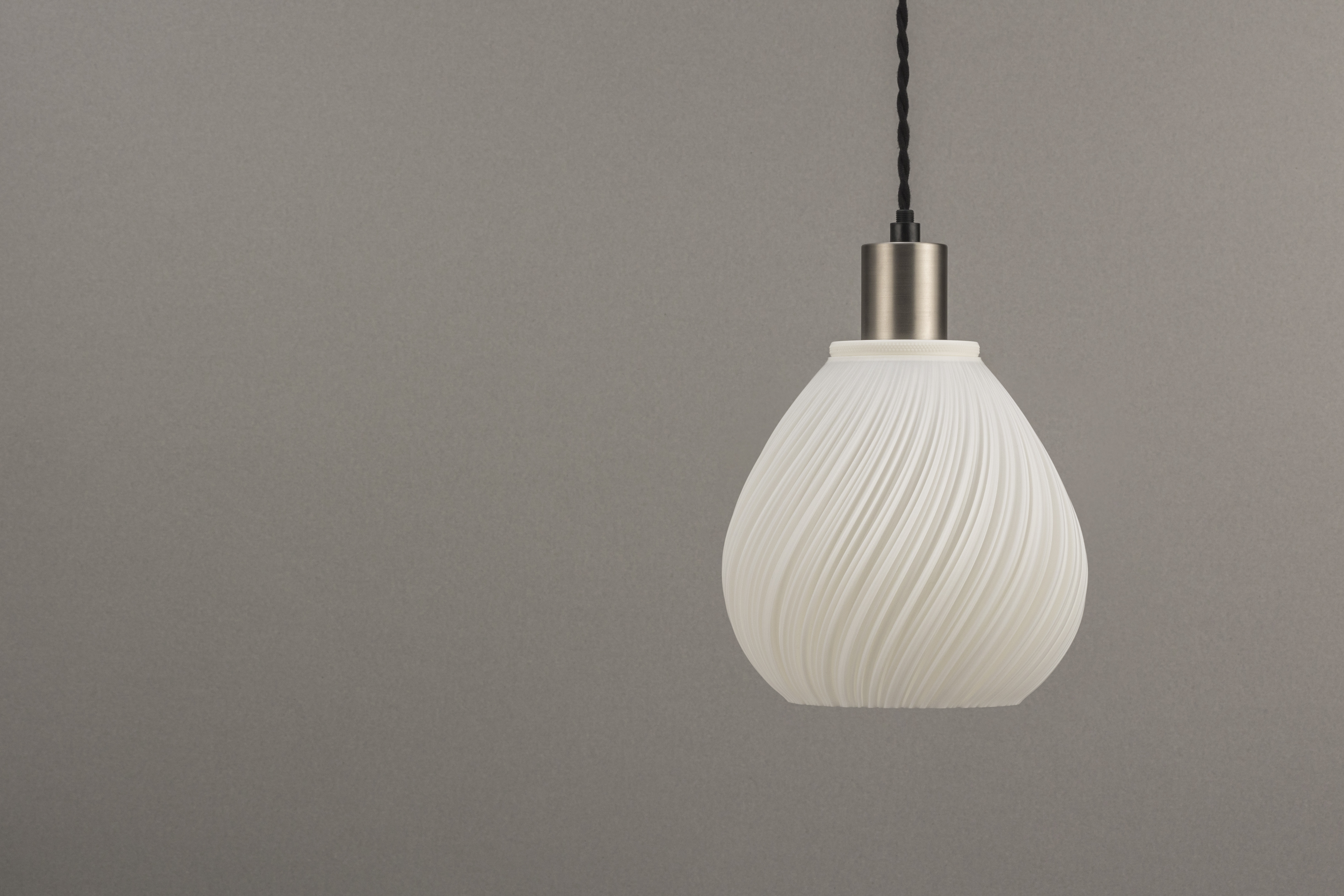 Decorative suggestion for Pellucid Sweep: Spiraling pleats pendant lampshade for a balletic light play. Transforms environments with mesmerizing beauty - variant Original (Milky white), an original product by Cosmic Jubilee (2 of 6) - presented as pendant light, hanging from ceiling, switched off.
