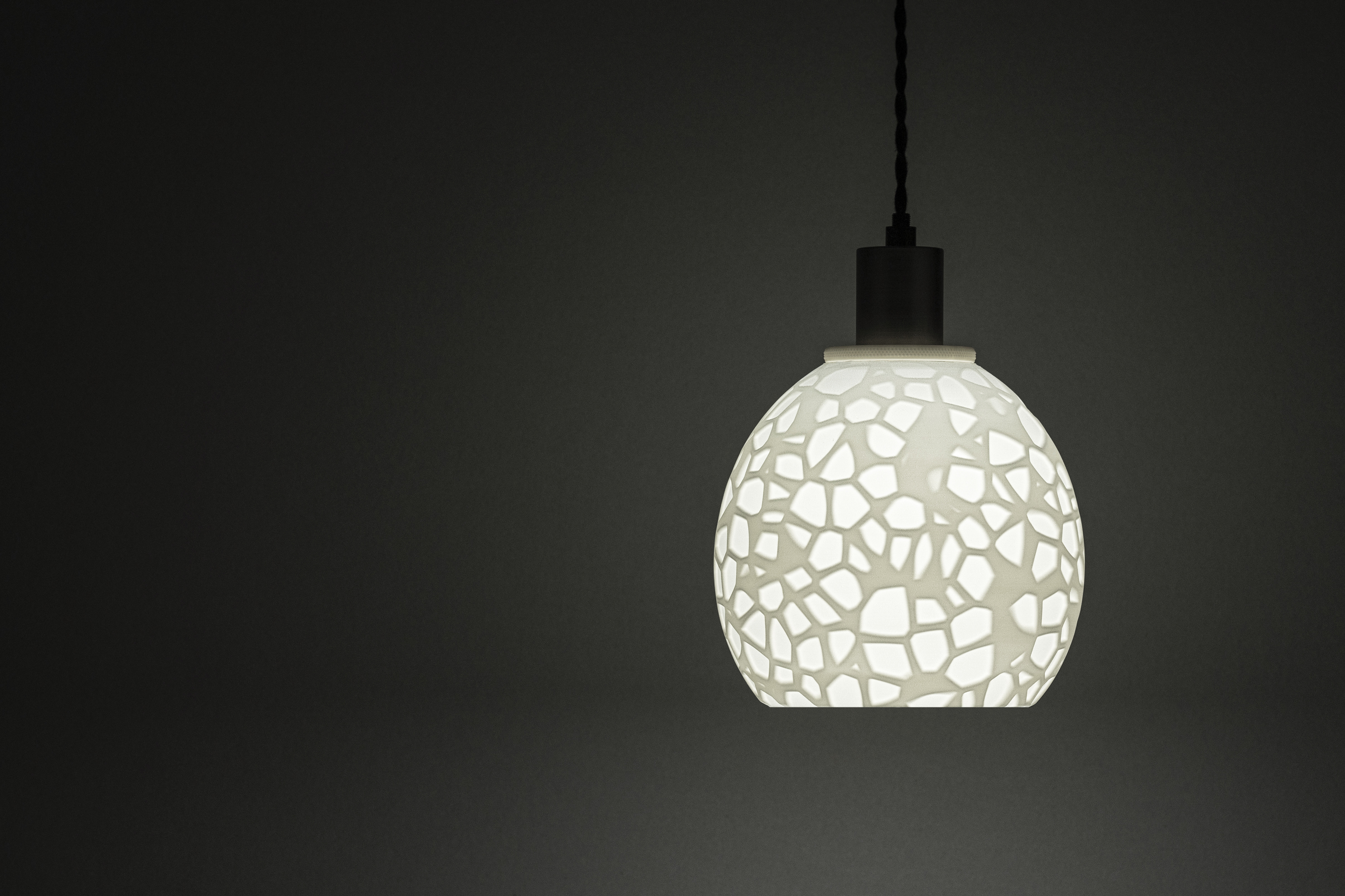 Decorative suggestion for Petrified Shallows: Pendant lampshade with timeless Voronoi design. Ideal for adding depth and history to your space - variant Original (Elegant white), an original product by Cosmic Jubilee (1 of 6) - presented as pendant light, hanging from ceiling, switched on.